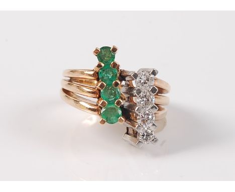 A contemporary emerald and diamond ring, the four slightly graduated round emeralds, set in a row 45 degrees to the band, wit