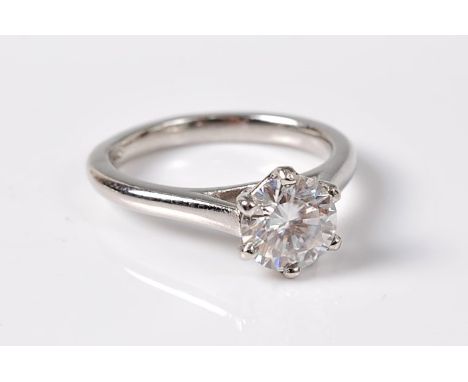 A white zircon and platinum ring, the round white zircon, approx. 7mm diameter, in a six claw setting to a plain band stamped