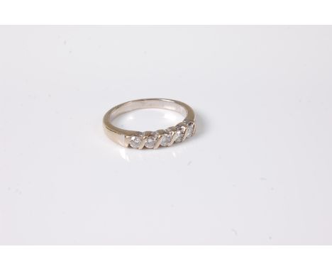 An 18ct five stone diamond ring, the five round brilliant cut diamonds, total estimated approx. 0.33cts, all set in white met