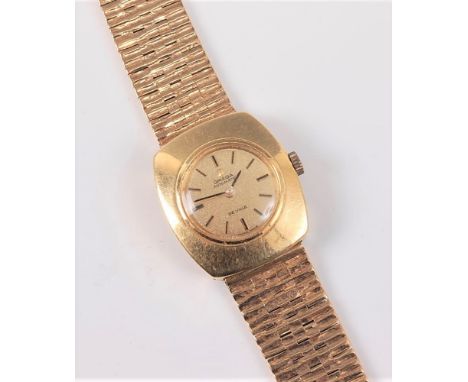 A lady's Omega de Ville Automatic wristwatch, the round champagne coloured dial, with gilt baton numerals and hands, in case 