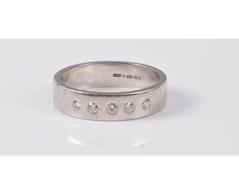 A platinum and diamond ring, the five round brilliant cut diamonds, total estimated approx. 0.10cts, set to a 5mm wide band, 