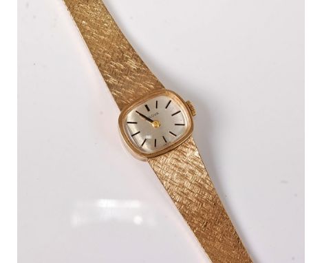 A lady's 9ct Bulova wristwatch, the oval silvered dial with black baton numerals and hands, inner case hallmarked Birmingham 