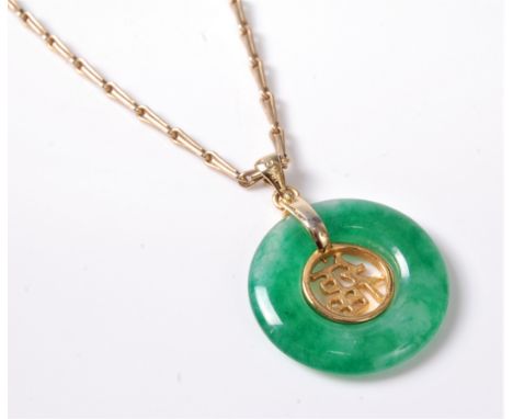 A Chinese jade pendant and 9ct chain, the round jade pendant with Chinese character set to centre, with associated chain stam