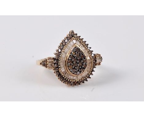 A 9ct diamond dress ring, the central pear shaped panel set with small round chocolate coloured diamonds, surrounded by a row