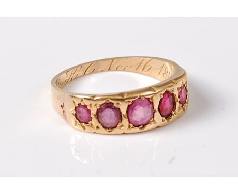 A late 19th century five stone ruby ring, the five oval graduated rubies, all set in yellow precious metal to a plain taperin