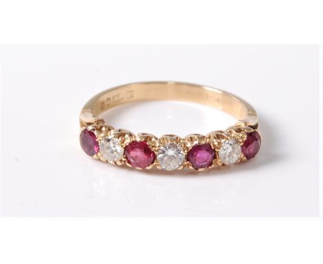 An 18ct ruby and diamond ring, the seven alternating rubies and round brilliant cut diamonds, total estimated weight of diamo