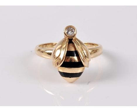 An '18k' diamond and enamel bee ring, the stylised bee with black enamel striped body and single stone diamond set head, all 