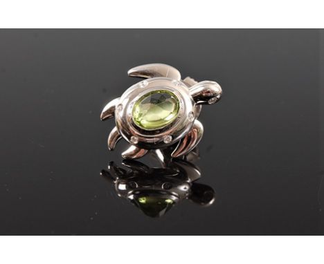 A peridot and diamond turtle lapel pin/brooch, the oval faceted peridot, in rubover mount and set with six small round diamon