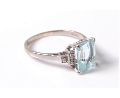 An early 20th century style aquamarine and diamond ring, the step cut aquamarine, approx. 9 x 7 x 5mm, with stepped shoulders