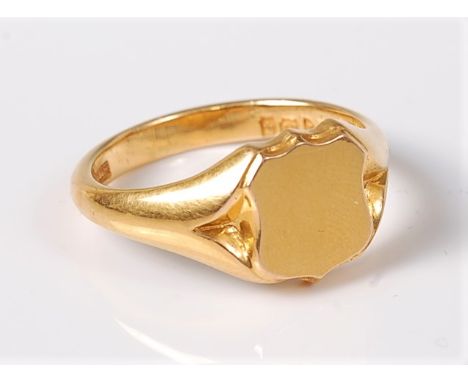 A gentleman's early 20th century 18ct blank signet ring, the blank shield set with tapered shoulders and plain band, hallmark