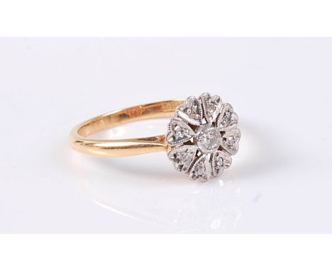 An 18ct diamond cluster ring, the central single cut diamond surrounded by eight small mixed cut diamonds each in a heart sha