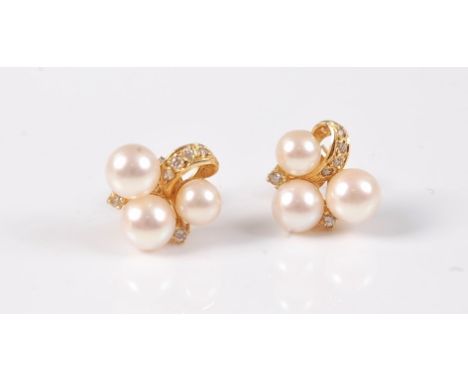 A pair of 18ct cultured pearl and diamond earstuds, the three cultured pearls, between approx. 4.7 - 5.7mm, set with an arc o