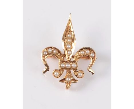 A '14ct' seed pearl fleur de lys brooch, the fleur de lys set throughout with seed pearls, stamped to reverse '14' (other mar