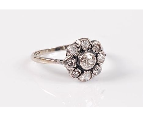 A diamond cluster ring, the central old diamond surrounded by smaller mixed cut diamonds, total estimated approx. 0.64cts, al