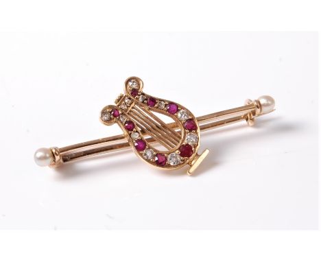A ruby and diamond lyre brooch, the alternating graduated rubies and diamonds set to the body of the lyre, set to a bar with 