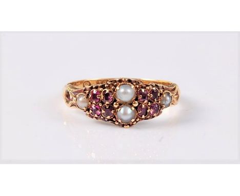 An 18ct Victorian ruby and pearl ring, the two central pearls set with four oval rubies to either side and a single pearl to 