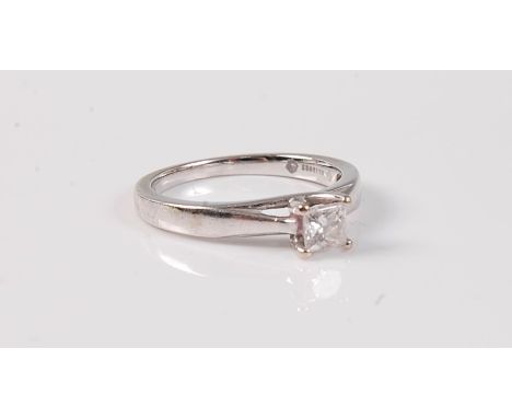 An 18ct diamond solitaire ring, the princess cut diamond, estimated approx. 0.30cts, in a four claw mount to plain band stamp