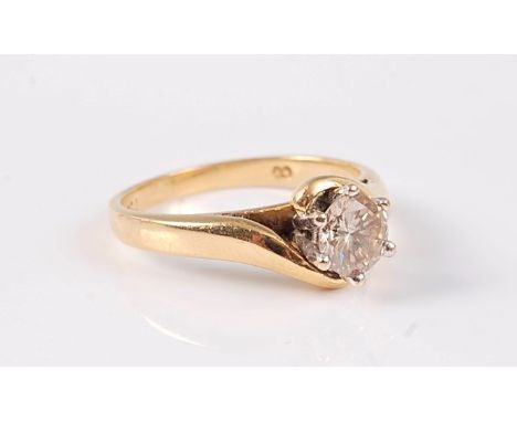 A diamond solitaire ring, the round brilliant cut diamond, estimated approx. 0.65cts, claw mounted in white metal to a crosso