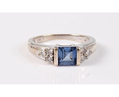 A synthetic sapphire and diamond ring, the pale cornflower blue synthetic sapphire, approx. 5.1 x 5.1mm, with three small rou