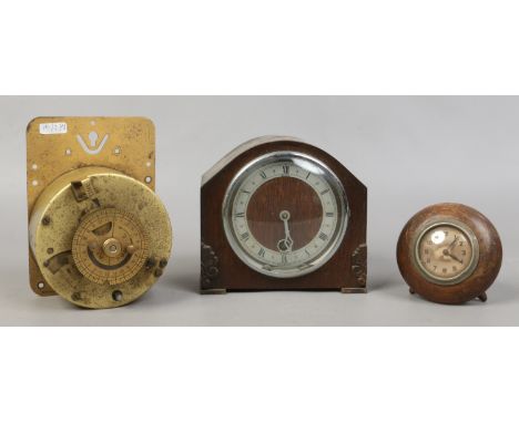 An oak cased mantel clock and a similar example, along with a 12 month timer mechanism.