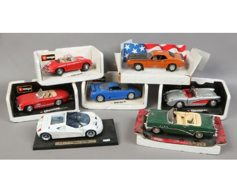 Seven 1/18 scale model cars on stands to include Burago, Maisto and Mira.