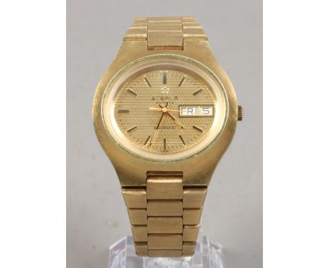 A gold plated Eterna quartz bracelet watch with centre seconds, date and day display.