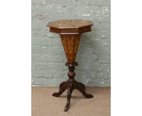 A mahogany marquetry inlaid tripod sewing table with fitted interior.