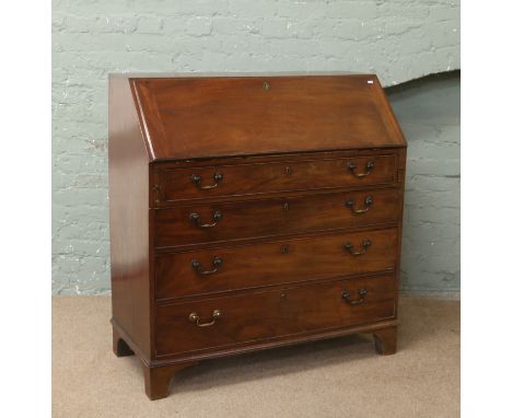 A Georgian mahogany bureau raised over bracket feet with fully fitted interior.