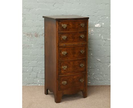 A carved bur walnut six drawer Wellington chest with brush slide raised on bracket feet.