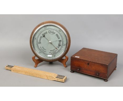 An antique single drawer mahogany box, oak framed wall barometer and a folding ruler.