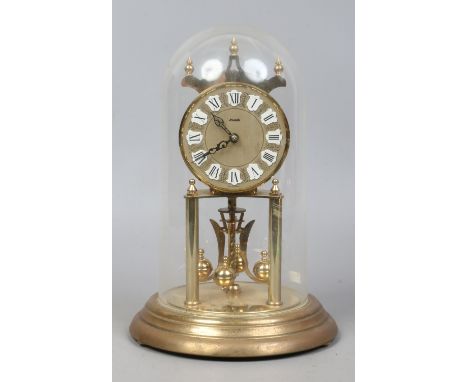A German Kundo brass torsion clock under dome by Kieningler & Obergfell.