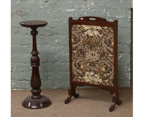 A firescreen and a carved mahogany torchere.