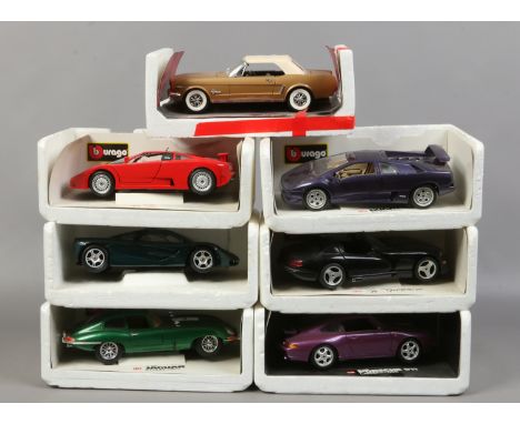 Seven 1/18 scale model cars on stands to include Burago, Maisto and Mira.