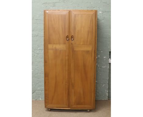 An Ercol chestnut wardrobe.