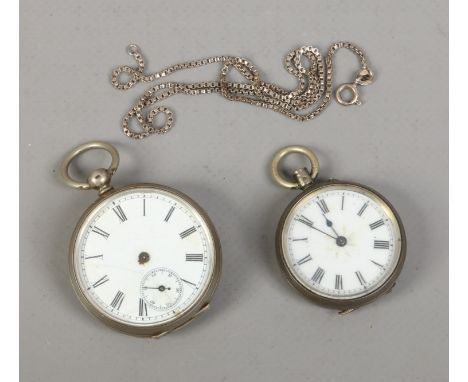 Two silver cased fob watches with white enamel dials, along with a silver necklace.