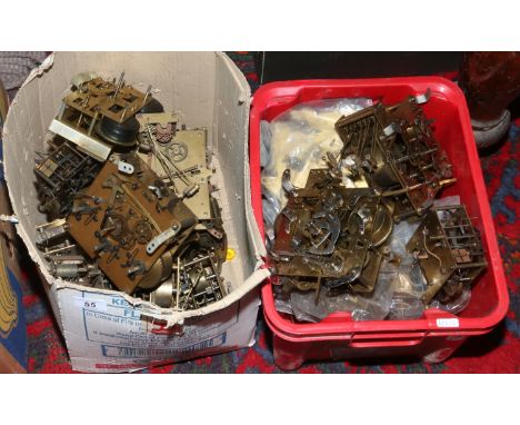 Two boxes of clock movements.