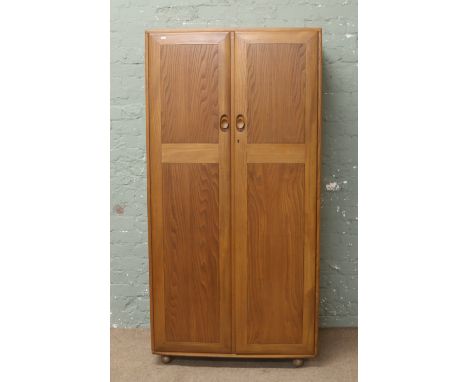 An Ercol chestnut wardrobe.