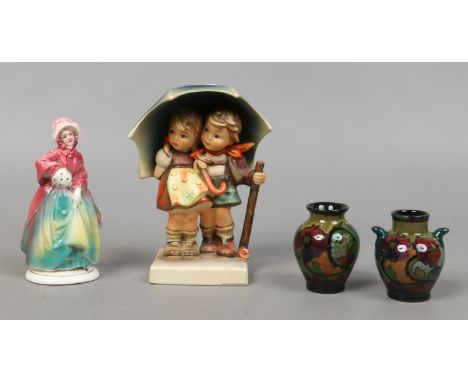 A Goebel M. J. Hummel figure of a boy and girl with umbrella, two miniature Gouda pottery vases and a Katzhutte pottery figur