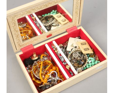 A jewellery box and assorted costume jewellery including maber and jade effect pieces.