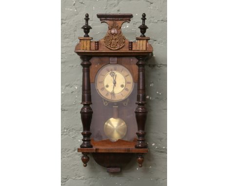 A walnut cased 8 day Vienna wall clock chiming on a coiled gong.