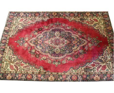 A red ground Persian Tabreze carpet with floral medallion design, made in Iran 288 x 186cm