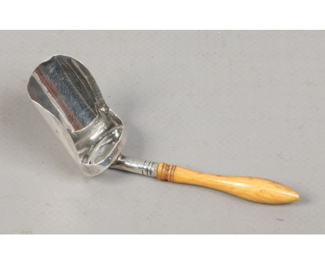 A George III silver caddy spoon with turned ivory handle, assayed Birmingham 1809.