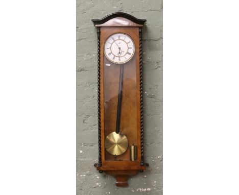 A 19th century walnut cased Vienna wall clock with ebonized sugar twist decoration, enamel and brass subsidiary second dial, 