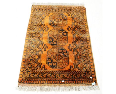 A vintage 20th century Persian Islamic carpet floor rug. In earthly tones with repeating geometric pattern, and Gul manner me