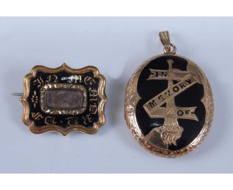 A yellow metal mourning brooch and locket, the shield shaped brooch having a scalloped edge and inlaid with black enamel and 