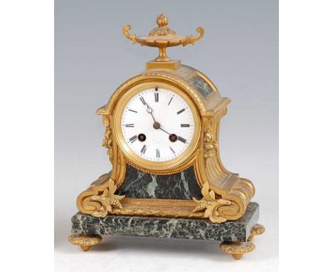 A late 19th century French gilt bronze and verdigris marble mantel clock, in the Louis XVI style, the twin handled urn finial