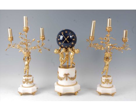 A 19th century French gilt bronze and white marble clock garniture, the clock modelled as three cherubs supporting a blue ena