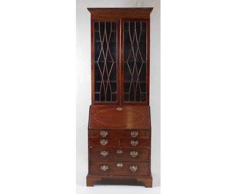 *An early George III mahogany bureau bookcase, of narrow proportions, having a replacement dentil moulded cornice over twin a