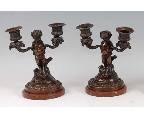 A pair of late 19th century French bronze twin branch dwarf figural candelabra, in the manner of Claude Michel Clodion, the s