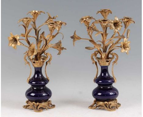 A pair of late 19th century French Rococo Revival gilt bronze and blue glazed porcelain candelabra, each having floral scroll